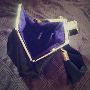 Black accessory bag with purple interior